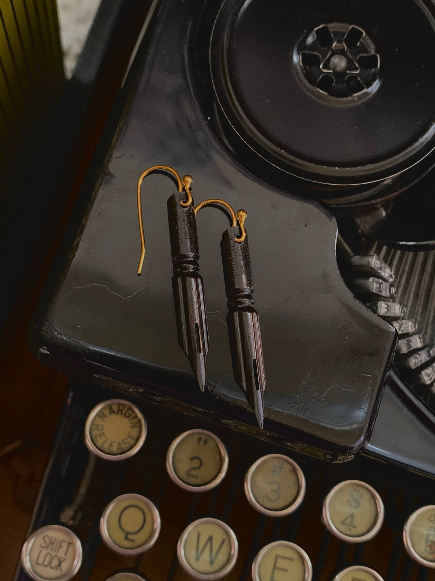 Pendientes góticos negros con punta de pluma francesa y alambres chapados en oro. Adornos oscuros y melancólicos para las orejas de estilo monótono.